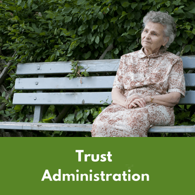 sad elderly lady sitting by herself on a bench